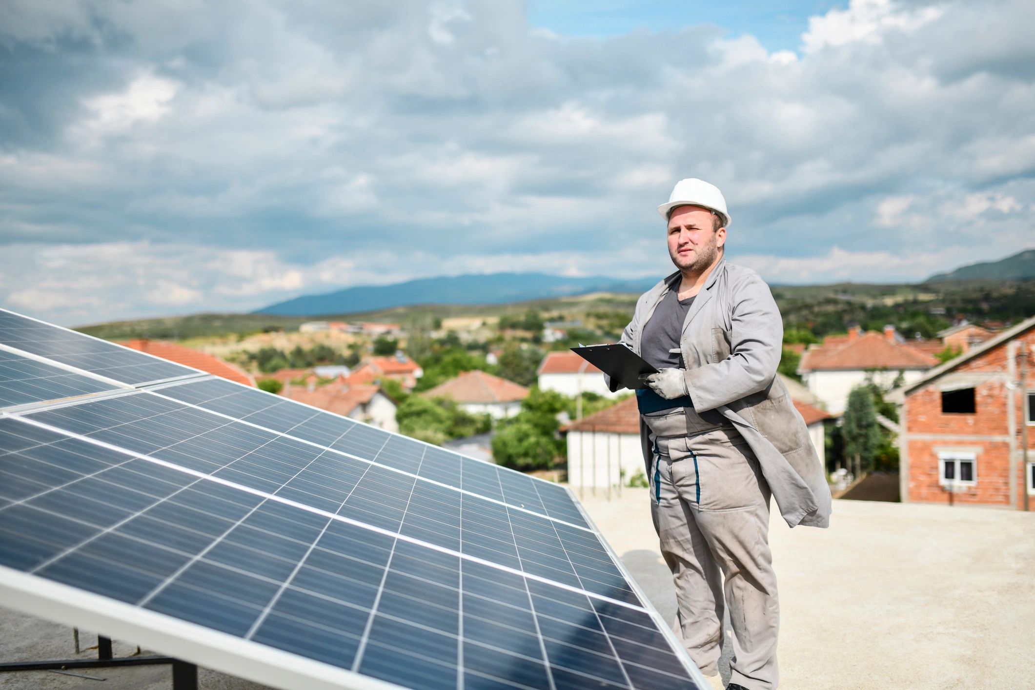 Worker inspecting installed photovoltaic panel
