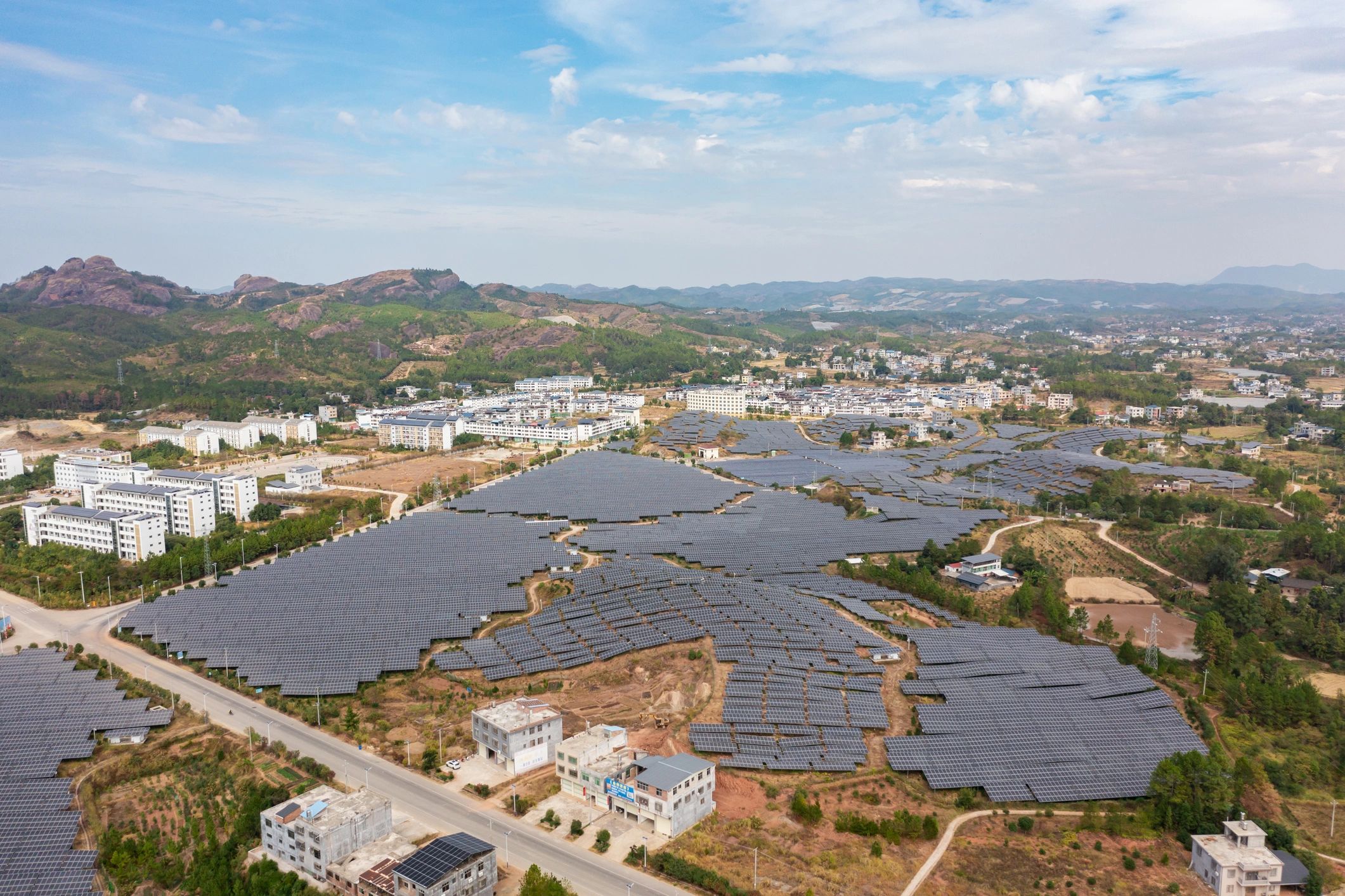 Aerial view of a large solar power plant near a town