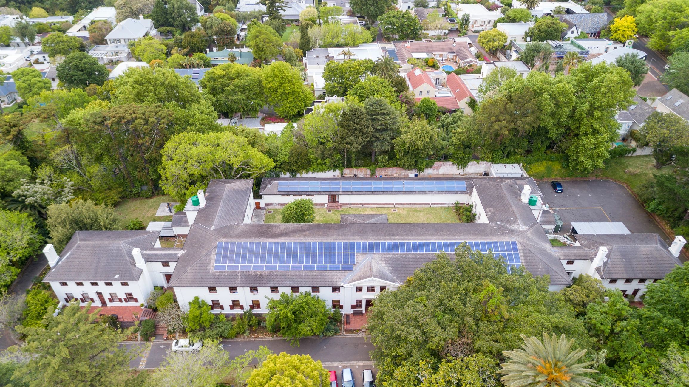 Wide aerial view of a building with rooftop solar panels