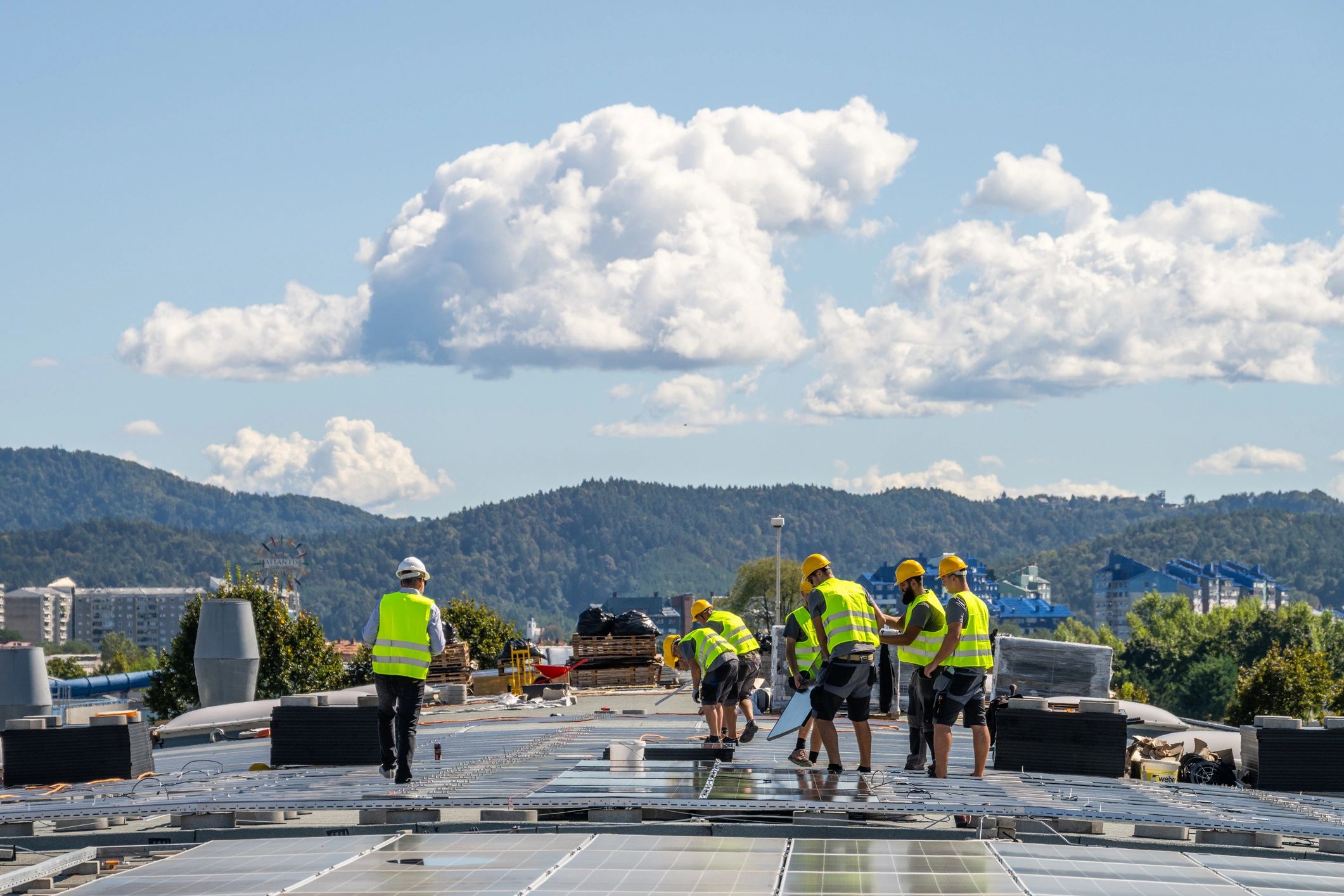 Team installing solar panels on a roof