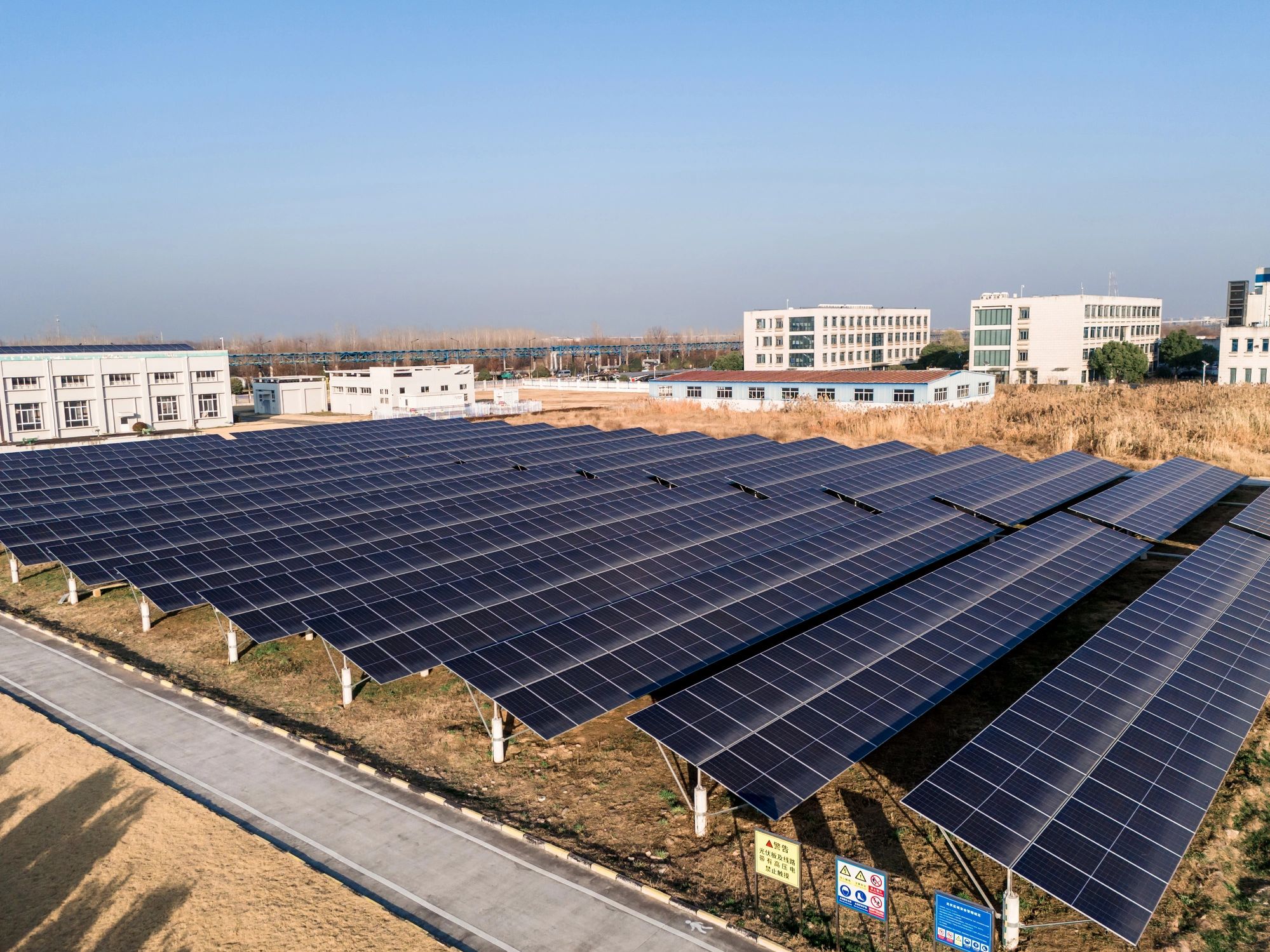Aerial view of solar panels on a grassy field